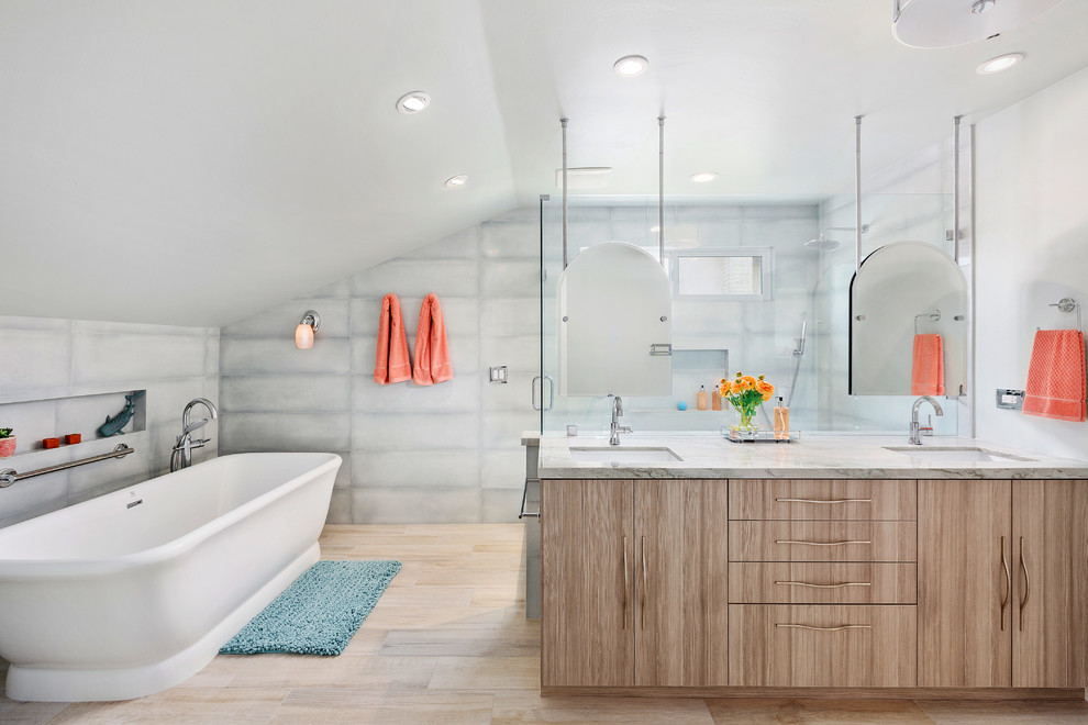 Large beach style master bathroom in Tampa with flat-panel cabinets, a freestanding tub, an open shower, porcelain tile, porcelain floors, an undermount sink, quartzite benchtops, a hinged shower door, medium wood cabinets, beige floor and grey benchtops.