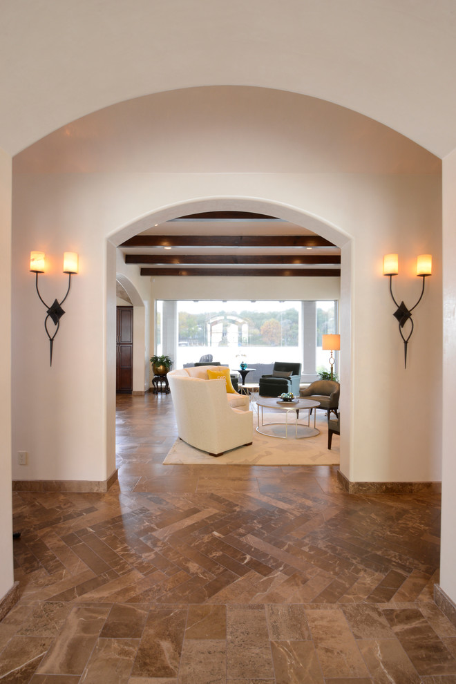 Design ideas for a large mediterranean foyer in Austin with white walls, marble floors, a double front door and a dark wood front door.