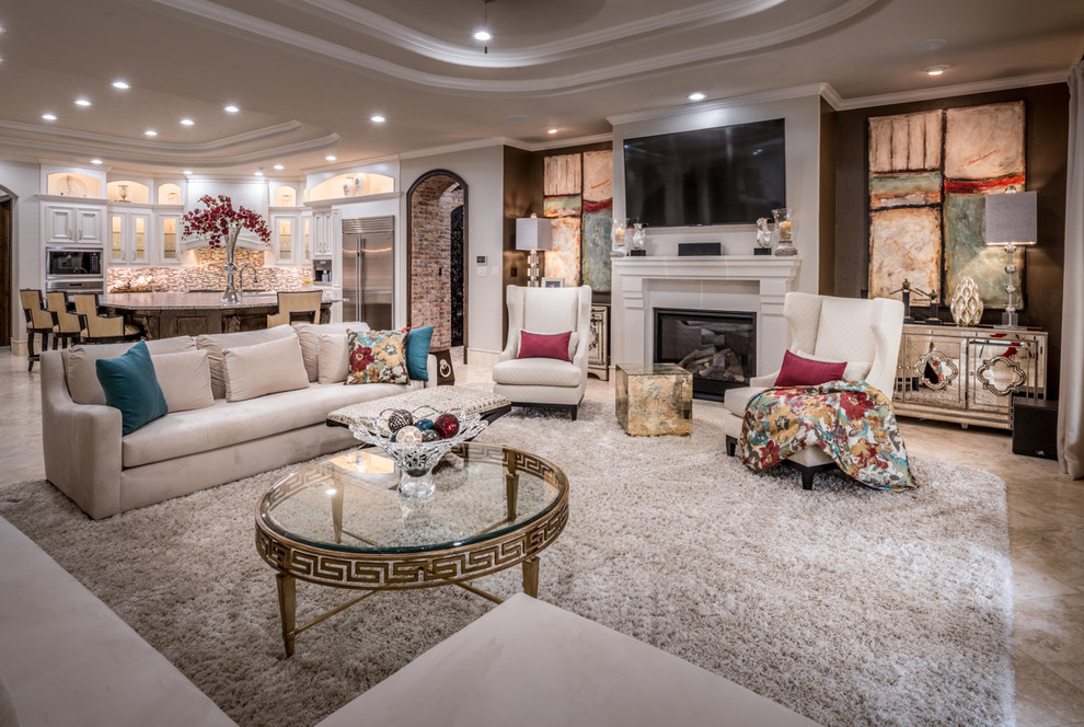 This is an example of a large contemporary open concept living room in Houston with beige walls, travertine floors, a standard fireplace, a stone fireplace surround, a wall-mounted tv and beige floor.