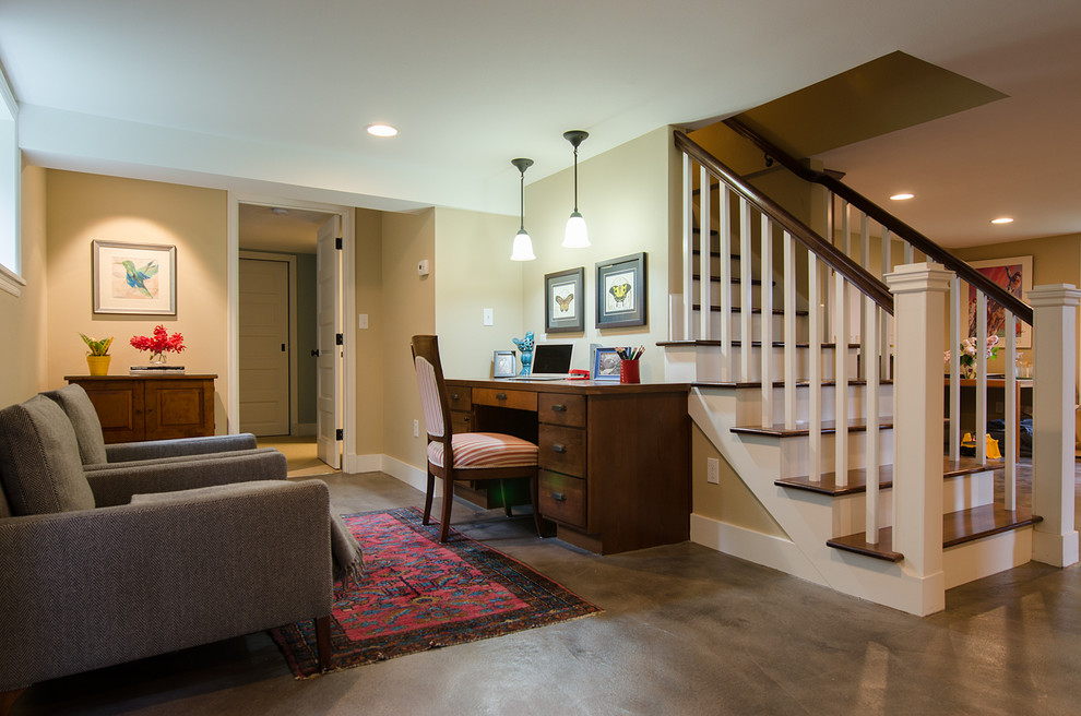 Photo of a mid-sized arts and crafts walk-out basement in Seattle with concrete floors, beige walls and grey floor.