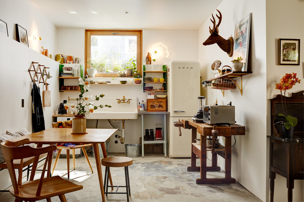 Photo of an eclectic kitchen in Seattle with concrete floors.