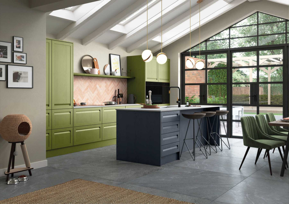 Photo of a medium sized contemporary single-wall open plan kitchen in Other with a built-in sink, shaker cabinets, green cabinets, composite countertops, orange splashback, brick splashback, black appliances, an island and white worktops.