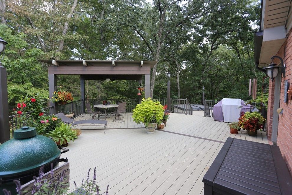 Design ideas for a large contemporary backyard deck in St Louis with a pergola.