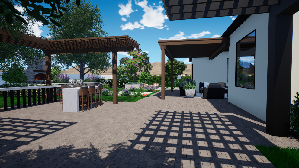 Immagine di un patio o portico tradizionale dietro casa con pavimentazioni in pietra naturale e una pergola