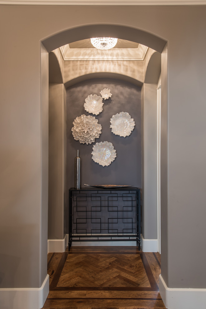 Inspiration for a mid-sized transitional medium tone wood floor hallway remodel with gray walls