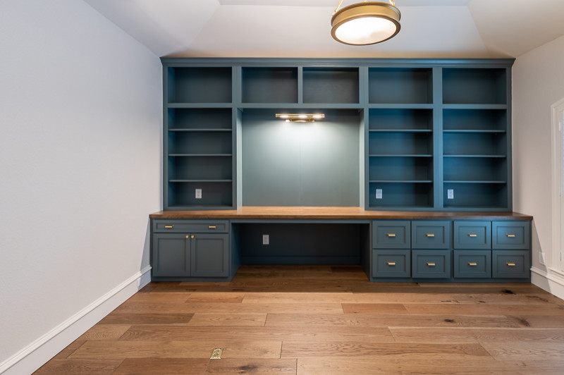 Medium sized classic study in Dallas with grey walls, medium hardwood flooring and a built-in desk.