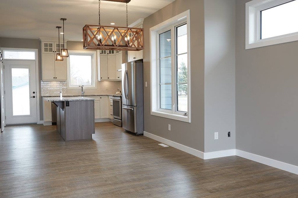 Inspiration for a mid-sized transitional dark wood floor and brown floor eat-in kitchen remodel with shaker cabinets, white cabinets, granite countertops and an island