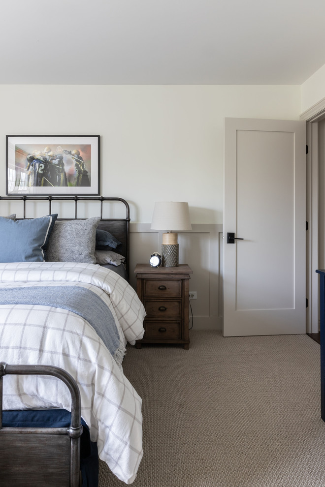 Derby House Kids Wing - Newly remodeled boys bedroom with new batten board wainscoting, closet doors, trim, paint, lighting, and new loop wall to wall carpet. Queen bed with windowpane plaid duvet. Photo by Emily Kennedy Photography.