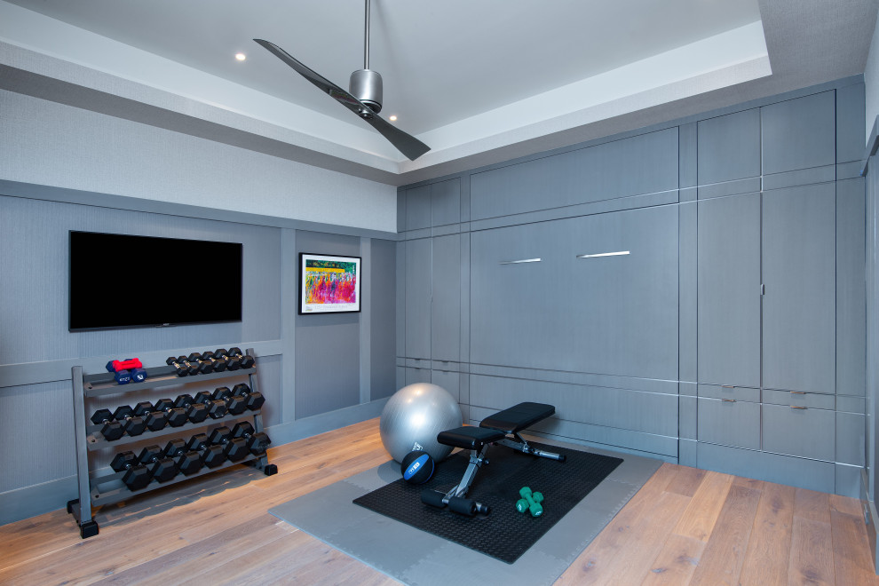 Inspiration for a mediterranean home gym in Miami with medium hardwood floors and recessed.