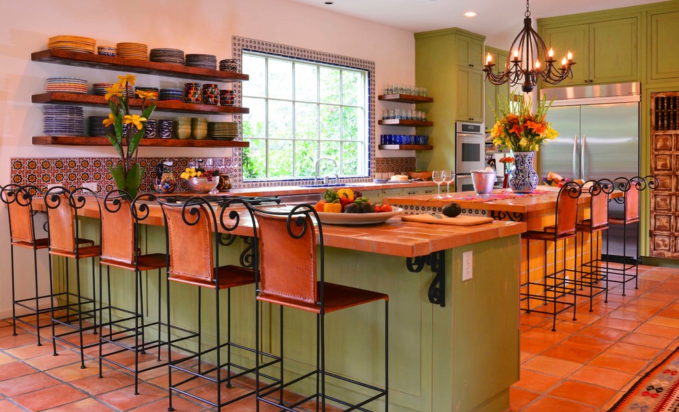 Large tuscan u-shaped terra-cotta tile and red floor open concept kitchen photo in Houston with open cabinets, green cabinets, multicolored backsplash, mosaic tile backsplash, stainless steel appliances, an island, an undermount sink and tile countertops