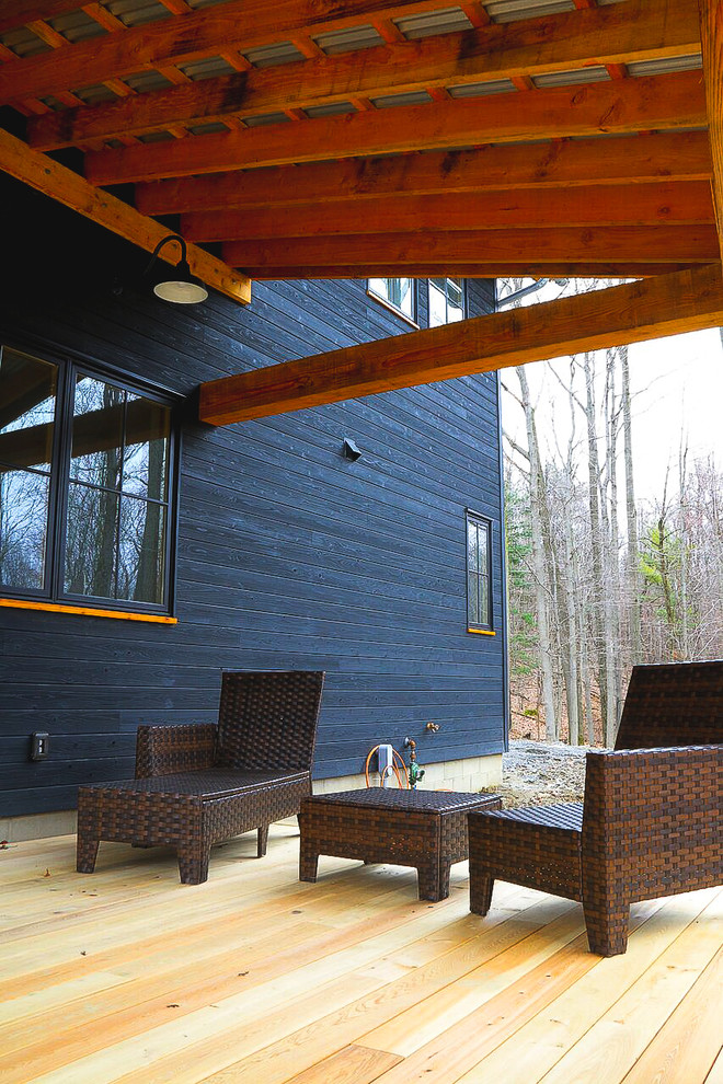 Inspiration for a large country three-storey black house exterior in New York with wood siding and a metal roof.
