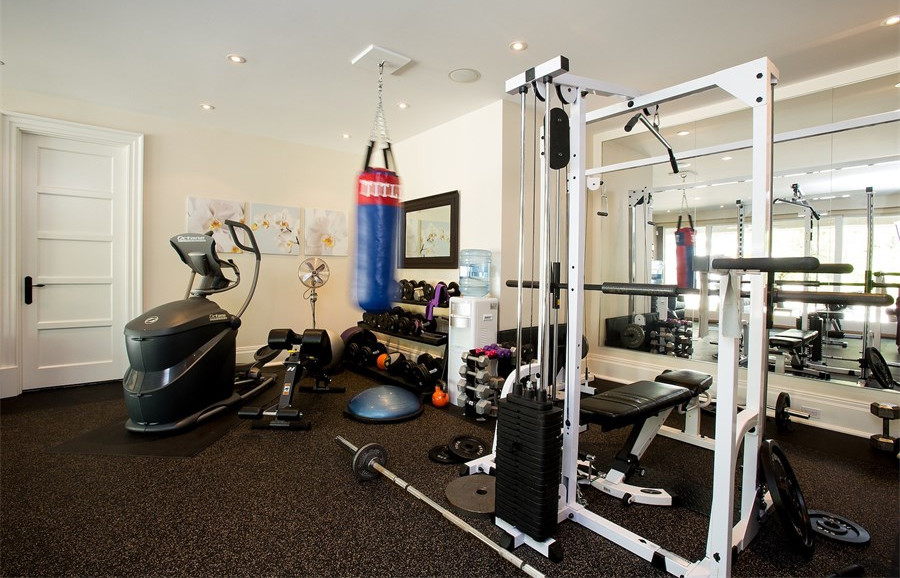 This is an example of a mid-sized beach style home weight room in Newark with beige walls.