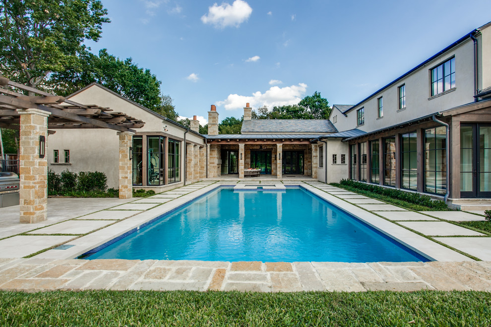 Inspiration for a mediterranean courtyard rectangular pool in Dallas with a hot tub.