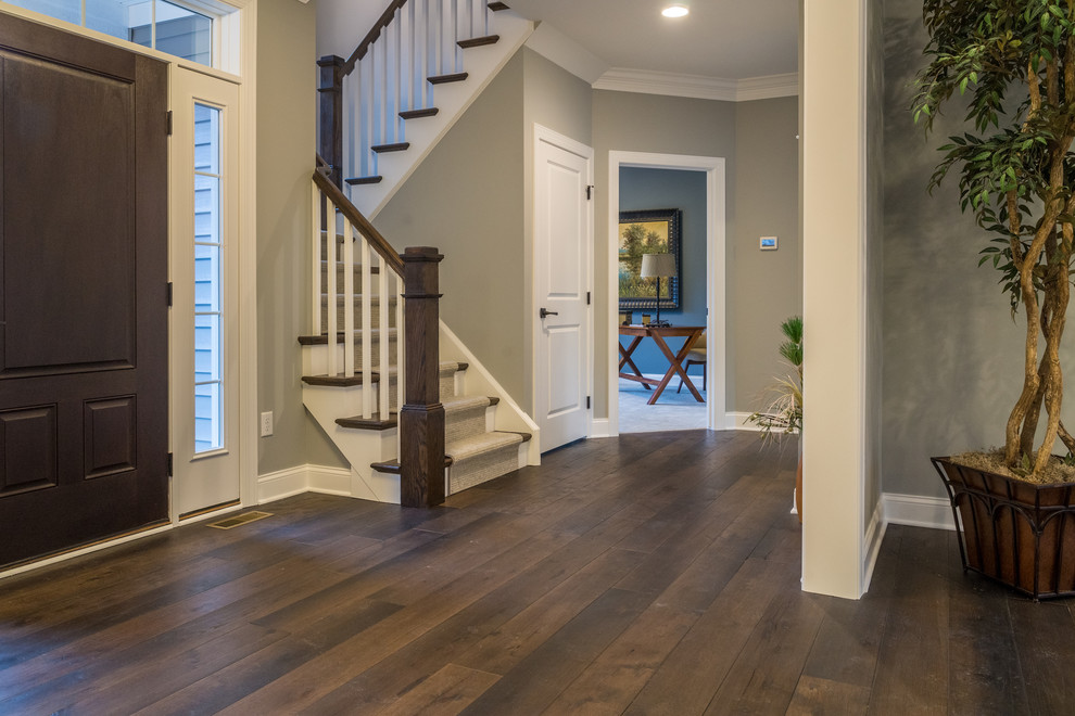 Inspiration for a large modern foyer in New York with dark hardwood floors and brown floor.