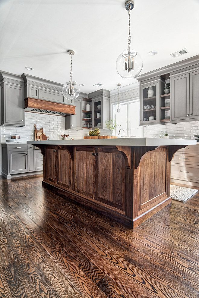 Photo of a large traditional l-shaped open plan kitchen in Columbus with a farmhouse sink, beaded inset cabinets, grey cabinets, marble benchtops, white splashback, subway tile splashback, stainless steel appliances, dark hardwood floors, with island, brown floor and white benchtop.