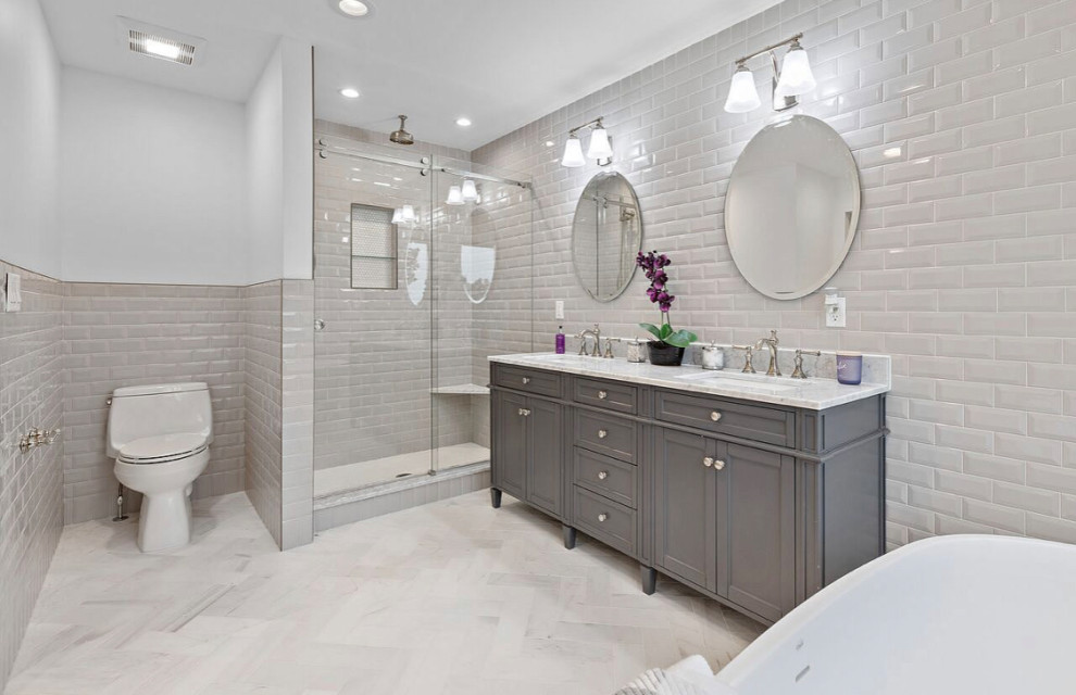 Example of a mid-sized transitional master bathroom design with shaker cabinets, marble countertops and white countertops