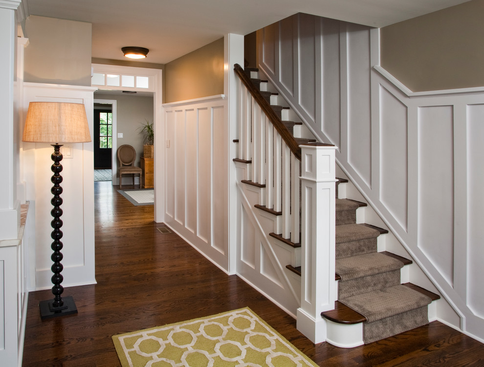 Photo of a mid-sized transitional carpeted straight staircase in Philadelphia with carpet risers and wood railing.