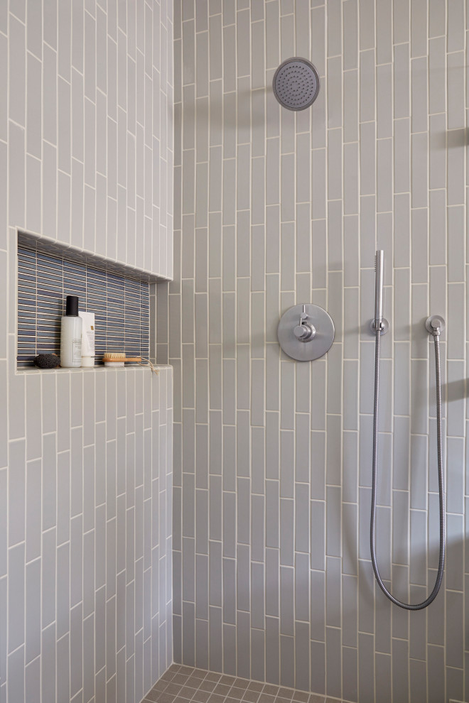 This is an example of a mid-sized midcentury master bathroom in San Francisco with flat-panel cabinets, brown cabinets, an alcove shower, a two-piece toilet, gray tile, ceramic tile, white walls, porcelain floors, an undermount sink, marble benchtops, grey floor, an open shower, white benchtops, a niche, a double vanity and exposed beam.