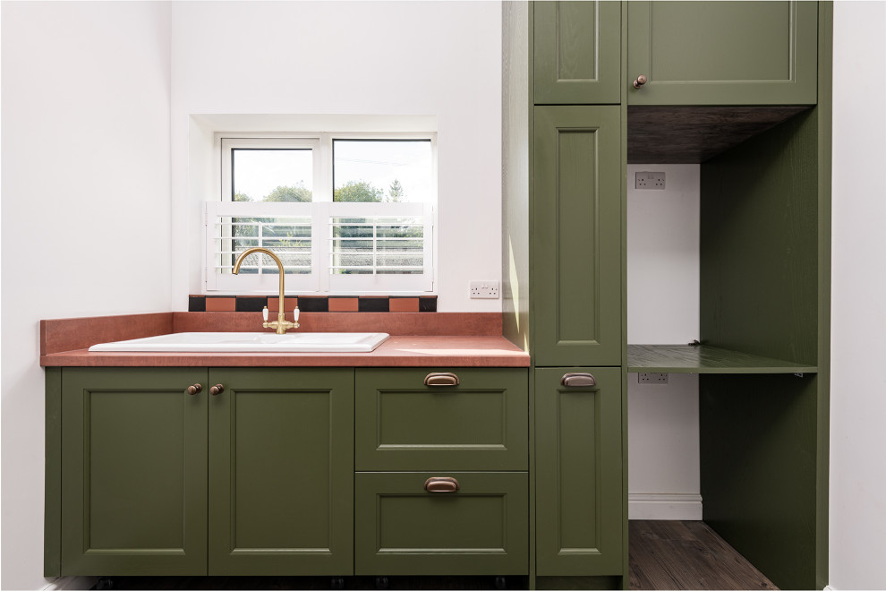 Design ideas for a large traditional laundry room in Kent with shaker cabinets and green cabinets.