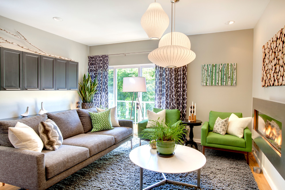 Example of a mid-century modern living room design in Seattle with gray walls