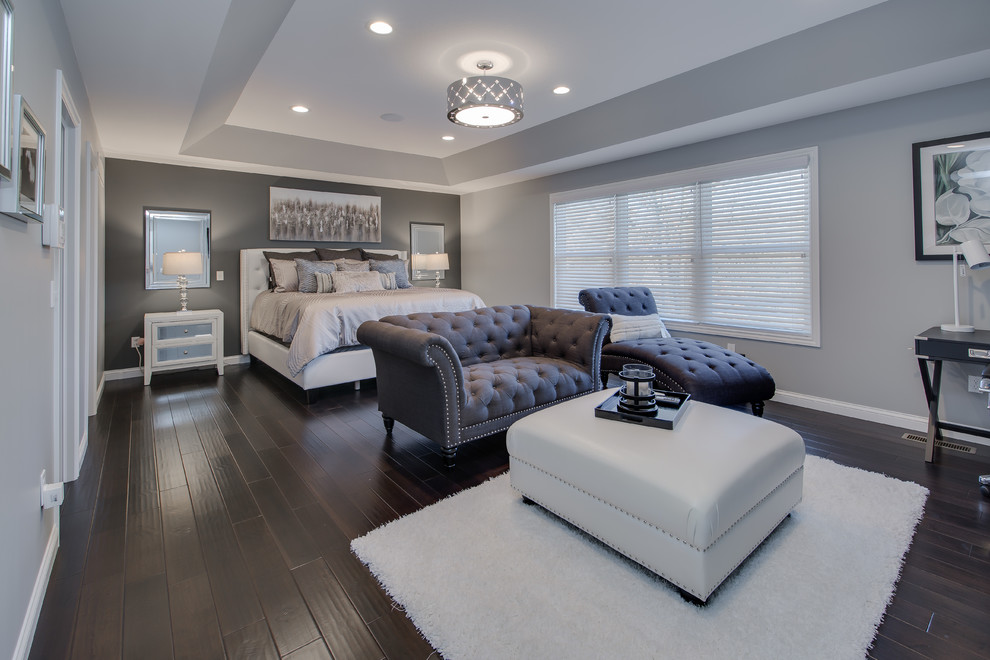 Transitional master bedroom in Grand Rapids with grey walls, dark hardwood floors, no fireplace and brown floor.