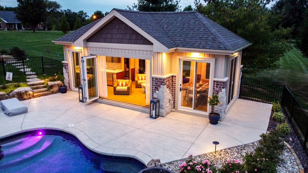 Diseño de casa de la piscina y piscina grande en patio trasero con suelo de hormigón estampado