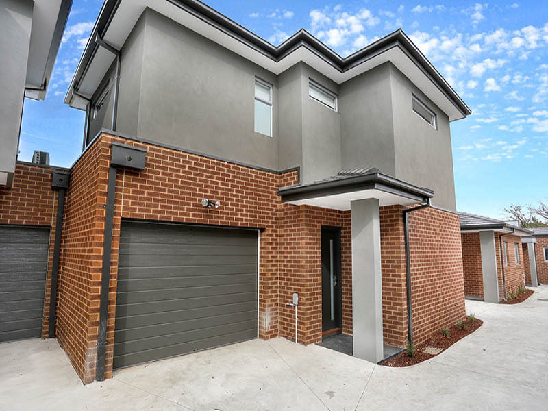 Photo of a mid-sized contemporary two-storey brick grey exterior in Melbourne with a gable roof.