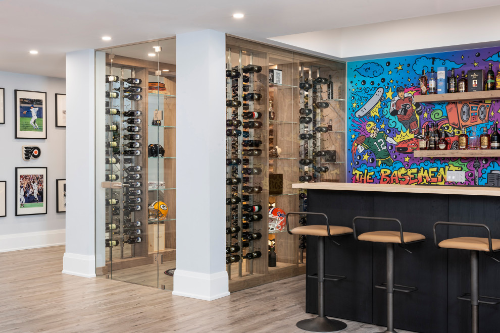 Design ideas for a mid-sized contemporary wine cellar in Toronto with light hardwood floors, display racks and brown floor.