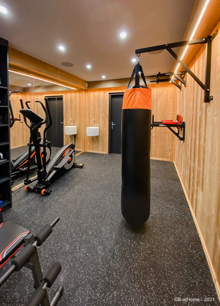 This is an example of a medium sized rustic home weight room in Other with multi-coloured walls, slate flooring and grey floors.