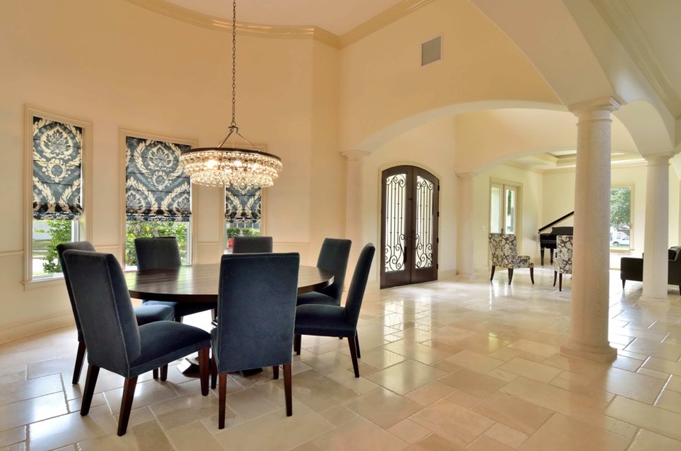 This is an example of an expansive mediterranean open plan dining in Tampa with white walls, travertine floors, beige floor and no fireplace.