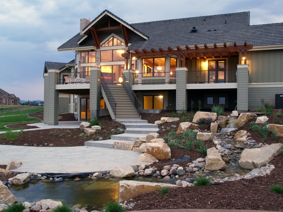 Photo of a large traditional one-storey grey exterior in Denver with wood siding and a gable roof.