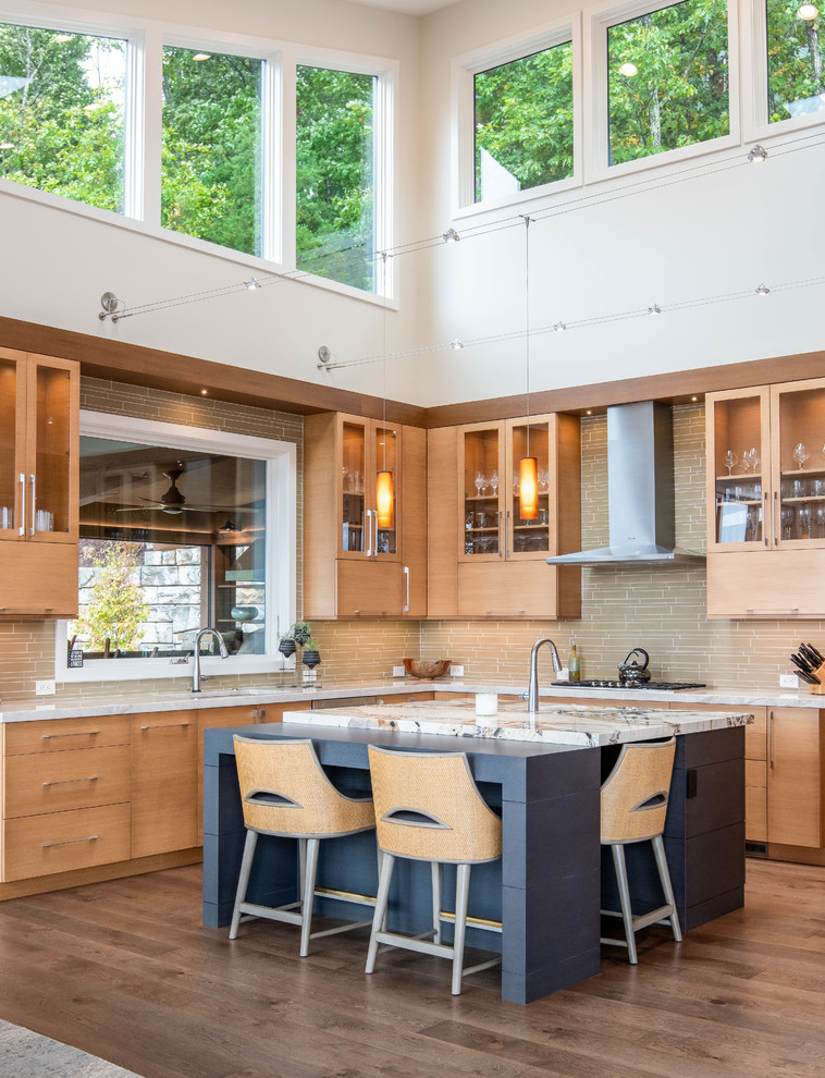 Photo of a mid-sized contemporary u-shaped eat-in kitchen in Other with flat-panel cabinets, medium wood cabinets, quartzite benchtops, beige splashback, stainless steel appliances, medium hardwood floors, with island, brown floor, multi-coloured benchtop and an undermount sink.
