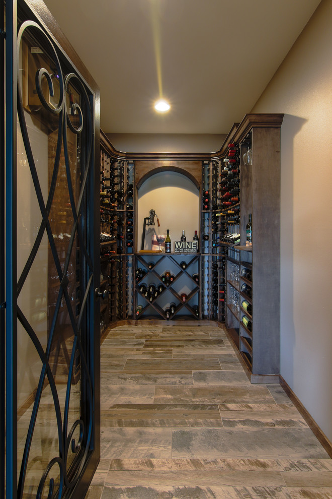 Example of a mid-sized mountain style ceramic tile and multicolored floor wine cellar design with diamond bins