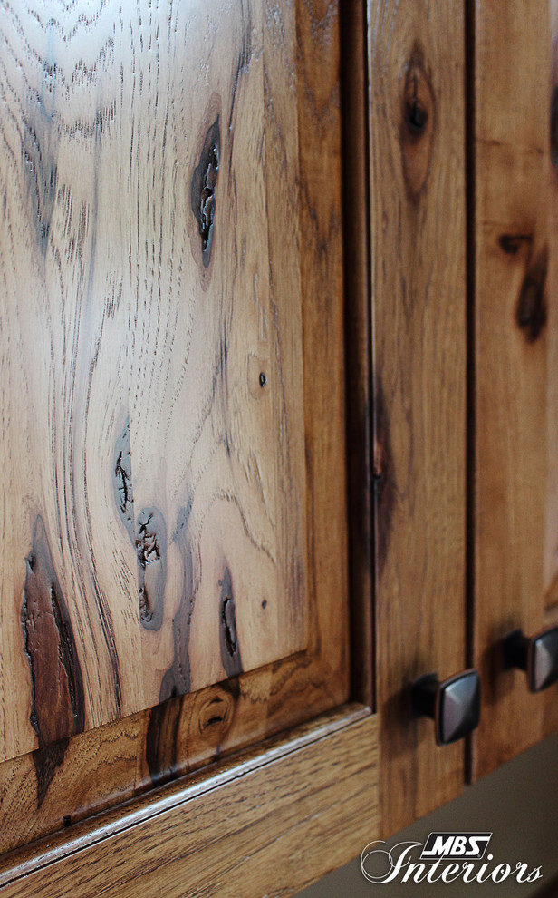 Inspiration for a rustic l-shaped kitchen remodel in Columbus with recessed-panel cabinets, medium tone wood cabinets, laminate countertops and black appliances