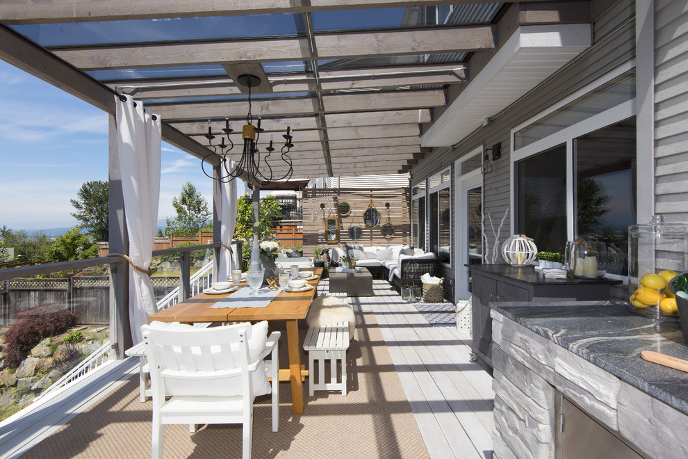 Inspiration for a large transitional backyard outdoor kitchen deck remodel in Vancouver with a pergola