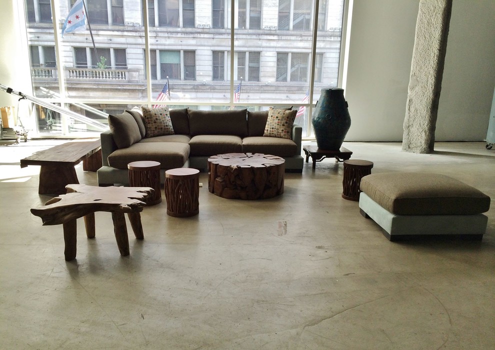 This is an example of an expansive industrial loft-style living room in Chicago with concrete floors.