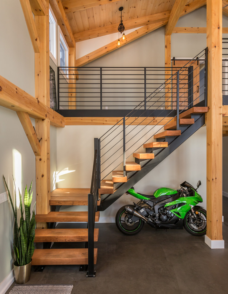 Inspiration for a mid-sized industrial wood l-shaped staircase in New York with open risers and metal railing.