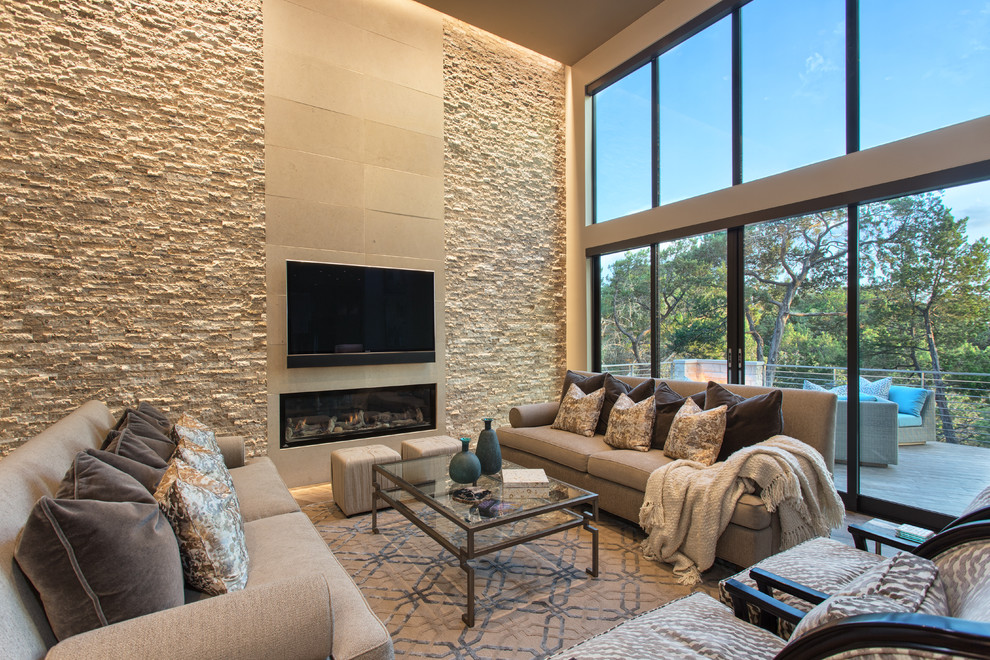 Inspiration for a contemporary formal living room in Austin with a ribbon fireplace, a stone fireplace surround and a wall-mounted tv.
