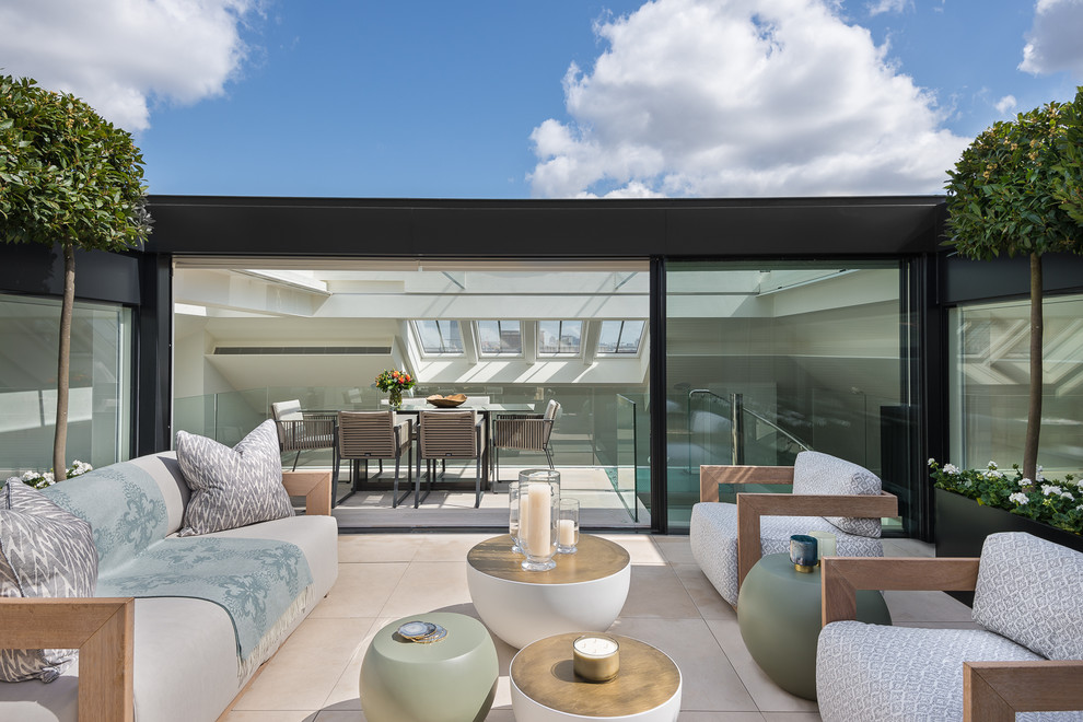 This is an example of a contemporary rooftop and rooftop deck in London with no cover.