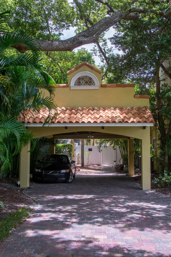 Design ideas for a mid-sized mediterranean detached two-car carport in Tampa.