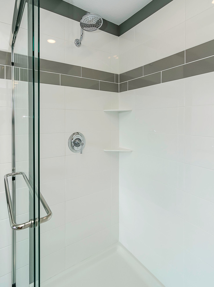 Inspiration for a mid-sized contemporary master bathroom in Minneapolis with shaker cabinets, black cabinets, an alcove tub, an alcove shower, gray tile, white tile, subway tile, grey walls, porcelain floors, an undermount sink and quartzite benchtops.