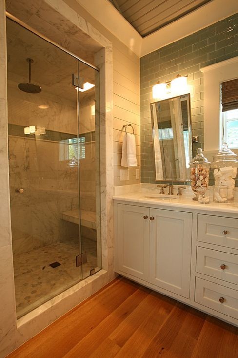 Inspiration for a mid-sized contemporary master wet room bathroom in Atlanta with flat-panel cabinets, white cabinets, a freestanding tub, multi-coloured tile, ceramic tile, white walls, medium hardwood floors, an undermount sink and limestone benchtops.