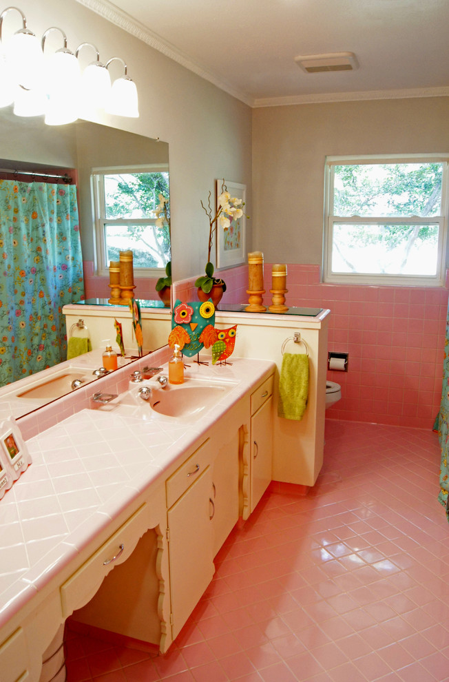Design ideas for a transitional bathroom in Dallas with pink tile and pink floor.