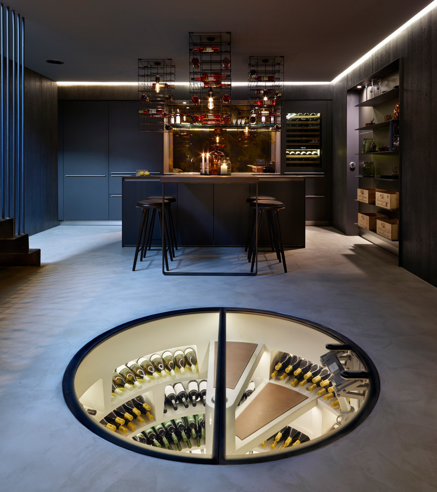 Photo of a mid-sized contemporary wine cellar in Los Angeles with concrete floors and storage racks.