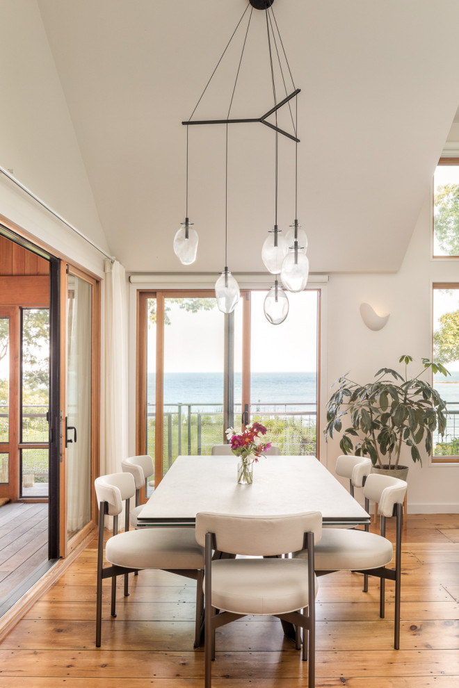 Example of a beach style dining room design in Portland Maine