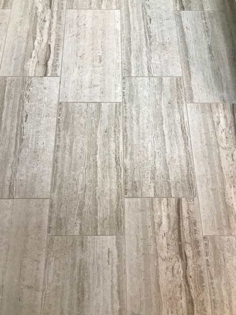 Inspiration for a mid-sized transitional galley porcelain tile and beige floor eat-in kitchen remodel with an undermount sink, flat-panel cabinets, beige cabinets, granite countertops, multicolored backsplash, mosaic tile backsplash, stainless steel appliances, a peninsula and white countertops