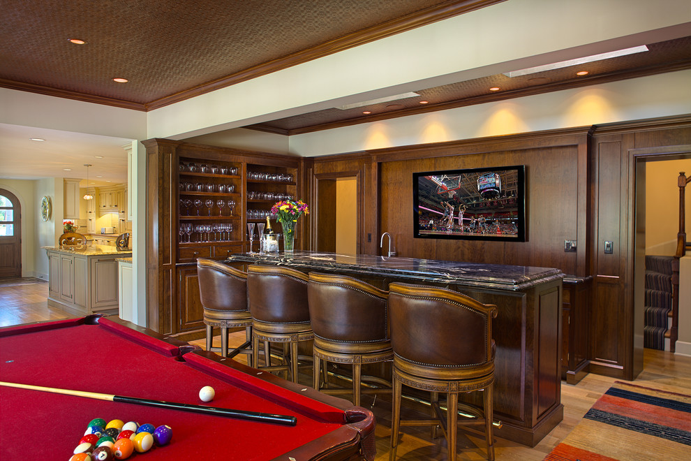 This is an example of a transitional home bar in Bridgeport.