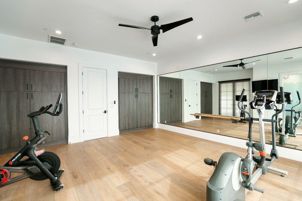 Photo of a large contemporary multipurpose gym in Phoenix with white walls, light hardwood floors and beige floor.