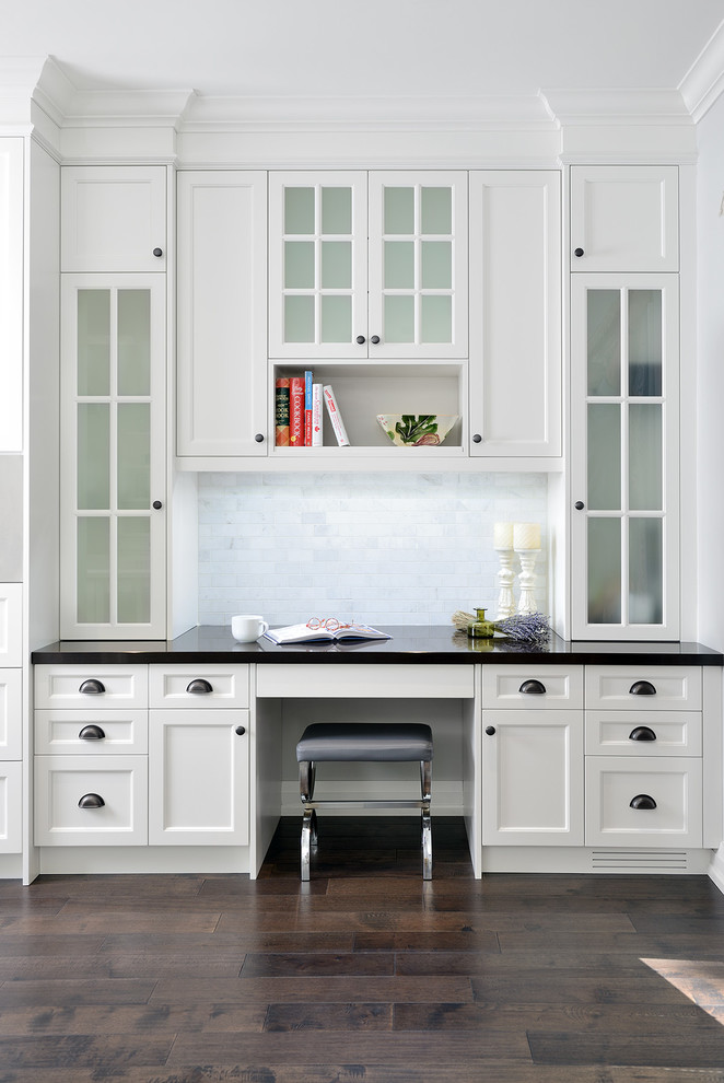 Inspiration for a mid-sized transitional l-shaped kitchen pantry in Toronto with an undermount sink, shaker cabinets, white cabinets, quartz benchtops, white splashback, subway tile splashback, stainless steel appliances, dark hardwood floors and with island.