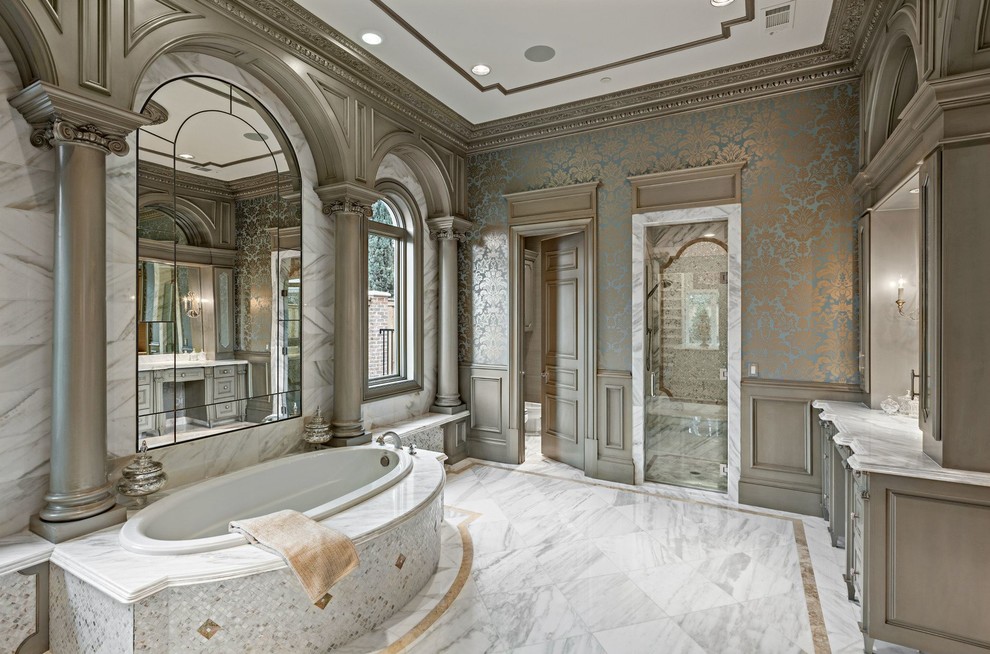 Inspiration for an expansive traditional master bathroom in Dallas with grey cabinets, a drop-in tub, white tile, an alcove shower, marble, multi-coloured walls, marble floors and marble benchtops.
